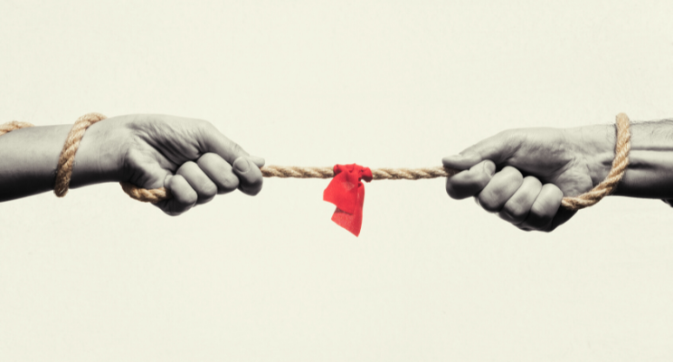 two hands holding a twine rope with a red flag in the middle.