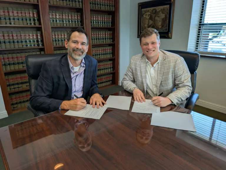 Marshall Dearing signing his partnership agreement with Jay Dryden at Vector Wealth Strategies